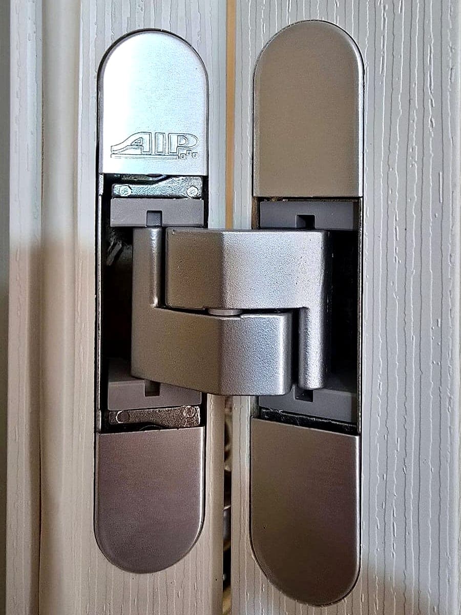 Dettaglio della cerniera a scomparsa regolabile di una porta interna effetto legno chiaro
